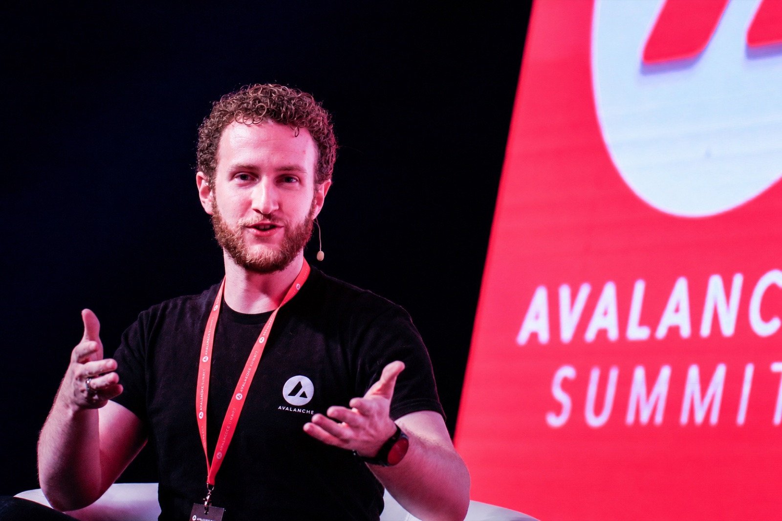 Connor speaking on stage at Avalanche Summit