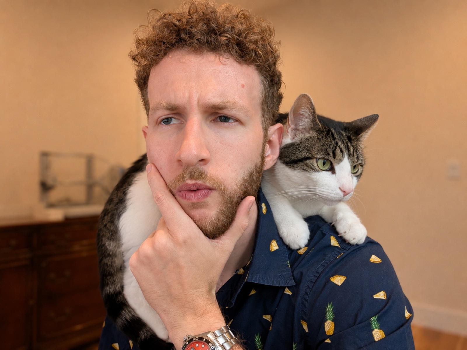 Connor thinking hard with a cat draped over his shoulders